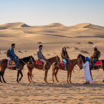 Camel caravan at sunset during Marrakech desert tour in Sahara
