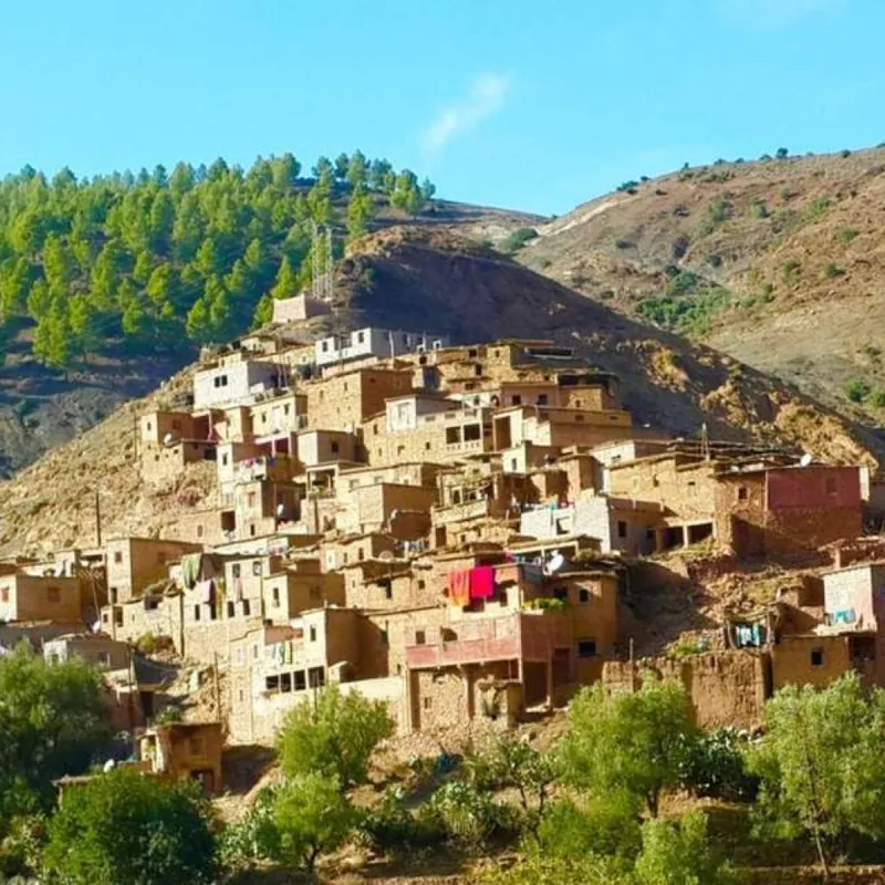 Hiking group exploring traditional village during Atlas Mountains day trip from Marrakech