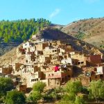 Hiking group exploring traditional village during Atlas Mountains day trip from Marrakech