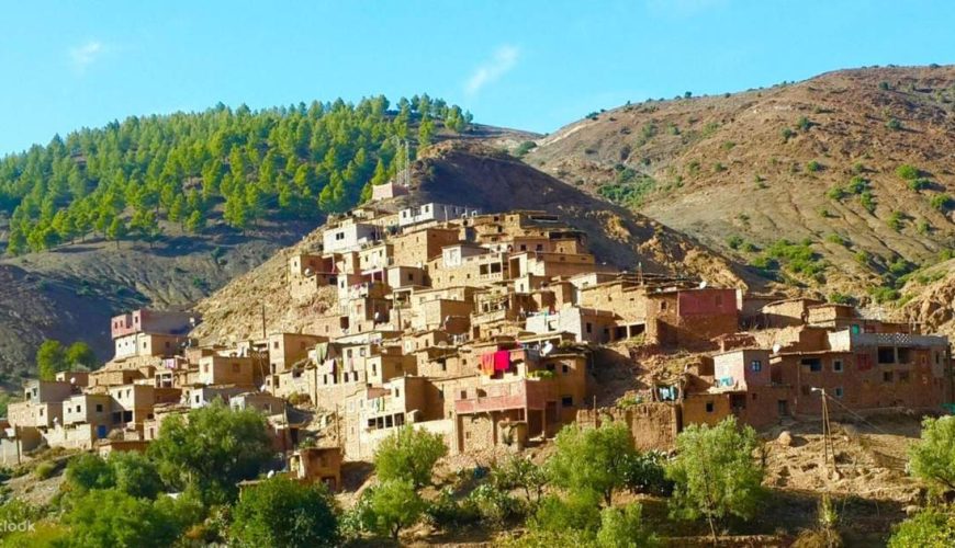 Hiking group exploring traditional village during Atlas Mountains day trip from Marrakech