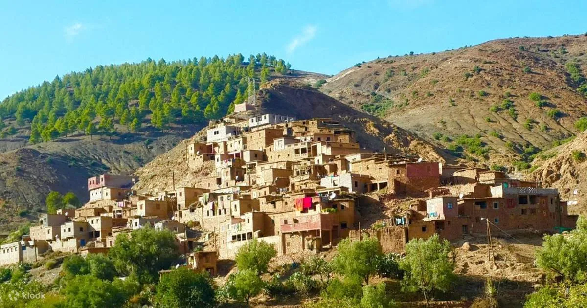 Hiking group exploring traditional village during Atlas Mountains day trip from Marrakech