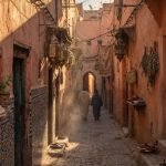 Travellers walking through a Marrakech medina alley at golden hour, one of the best things to do in Marrakech - Things do to