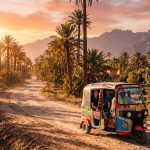 Travelers enjoying a tuk-tuk tour in Marrakech at sunset, one of the best things to do in Marrakech - Things do to in