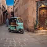 A green tuk tuk parked on a narrow lane in the Marrakech medina at golden hour - Tuk Tuk Marrakech